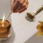 A candle being lit on a Caesarstone Solenna mineral kitchen worktop surface