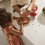Family cooking on a Caesarstone Dreamy Carrara mineral kitchen island