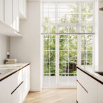 Caesarstone Brillianza Mineral Worktops and kitchen island in a garden facing white kitchen