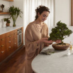 Caesarstone Brillianza mineral kitchen worktops paired with wooden cabinetry in a transitional kitchen